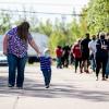 People wait in line at a mass vaccination and testing clinic at the Moncton Coliseum in Moncton, N.B., on Sept. 22.